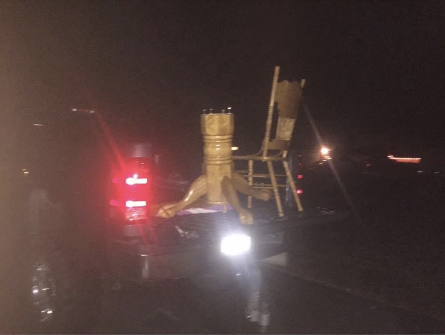 Furniture being delivered on a trailer at night