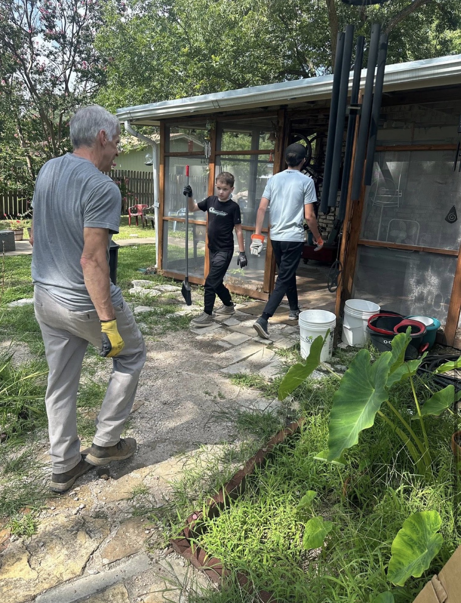 Helping with flood cleanup outside a home